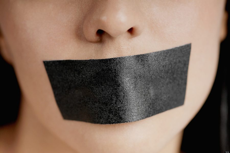 Close-up of a young woman with adhesive tape over her mouth